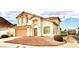 Well-maintained two-story home with desert landscaping, neutral tones, and a welcoming entrance at 66 John Stuart Mill St, Henderson, NV 89002