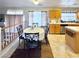 A combined kitchen and dining area with bright countertops, modern appliances, and natural light at 66 John Stuart Mill St, Henderson, NV 89002