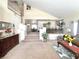 Bright living room with high ceilings, an open staircase, and views into the dining area at 66 John Stuart Mill St, Henderson, NV 89002