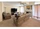Cozy living room featuring comfortable seating, fireplace, and a large television at 66 John Stuart Mill St, Henderson, NV 89002