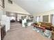 Spacious living room showcasing an open staircase, plush carpeting, and ample seating at 66 John Stuart Mill St, Henderson, NV 89002
