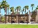 Scenic park featuring covered picnic areas, lush green lawns, and towering palm trees, perfect for gatherings at 66 John Stuart Mill St, Henderson, NV 89002