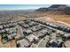 Expansive aerial view of a luxury neighborhood near the mountains, featuring homes with sparkling pools at 6832 Apogee Ridge Ct, Las Vegas, NV 89135