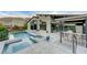 Inviting pool and spa with outdoor kitchen and lush landscaping at 6832 Apogee Ridge Ct, Las Vegas, NV 89135