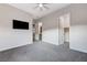Open bedroom space with plush carpeting and an access to bathroom and closet entrances for convenience at 6832 Apogee Ridge Ct, Las Vegas, NV 89135