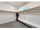 Spacious walk-in closet with ample shelving, hanging rods, and a convenient bench for organization at 6832 Apogee Ridge Ct, Las Vegas, NV 89135