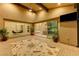 Spacious covered patio with decorative rug, ample seating, and views of the dining room, living room, and kitchen at 6832 Apogee Ridge Ct, Las Vegas, NV 89135