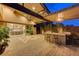Expansive covered patio featuring an outdoor kitchen and bar seating, perfect for entertaining guests at 6832 Apogee Ridge Ct, Las Vegas, NV 89135