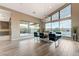Dining room with large windows overlooking outdoor living space and a modern chandelier at 6832 Apogee Ridge Ct, Las Vegas, NV 89135