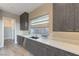 A modern kitchen with gray wood cabinets, stainless steel appliances, and a bright window at 6832 Apogee Ridge Ct, Las Vegas, NV 89135