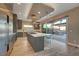 Modern kitchen with stainless steel appliances, a large island, and sliding doors to the outdoor patio at 6832 Apogee Ridge Ct, Las Vegas, NV 89135