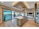 Gourmet kitchen featuring a marble-topped island, stainless steel appliances, and seamless access to the outdoor living area at 6832 Apogee Ridge Ct, Las Vegas, NV 89135