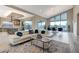 Open concept living area with kitchen, living room, dining room and views of the patio at 6832 Apogee Ridge Ct, Las Vegas, NV 89135