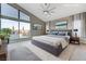 Bright main bedroom featuring a large window with a view, neutral tones and soft carpet at 6832 Apogee Ridge Ct, Las Vegas, NV 89135