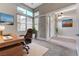 Bright home office featuring high ceilings, expansive windows, and stylish furnishings for a productive workspace at 6832 Apogee Ridge Ct, Las Vegas, NV 89135