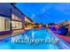 Stunning backyard pool area featuring modern design, a built-in bar, and lush landscaping, perfect for outdoor entertaining at 6832 Apogee Ridge Ct, Las Vegas, NV 89135