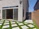 Backyard view showcasing artificial turf, desert landscaping, and access to side yard at 6837 Crimson Lily St, Las Vegas, NV 89139