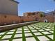 Backyard featuring a modern patio design with artificial turf and a desert landscape border at 6837 Crimson Lily St, Las Vegas, NV 89139