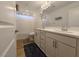 Bathroom features a double sink vanity with white cabinets, wood floors and modern fixtures, enhancing functionality at 6837 Crimson Lily St, Las Vegas, NV 89139