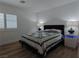 Well lit bedroom showcases a queen bed, side tables with lamps and stylish window shutters at 6837 Crimson Lily St, Las Vegas, NV 89139
