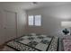 Comfortable bedroom with a decorative quilt, shutters, and spacious closet at 6837 Crimson Lily St, Las Vegas, NV 89139