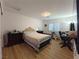 Inviting bedroom with wood floors, neutral walls, and a comfortable bed, creating a relaxing retreat at 6837 Crimson Lily St, Las Vegas, NV 89139