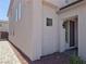 Contemporary home exterior with a dark brown front door and desert landscaping at 6837 Crimson Lily St, Las Vegas, NV 89139