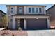 Contemporary two-story home featuring a two-car garage and desert landscaping at 6837 Crimson Lily St, Las Vegas, NV 89139