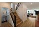 Open foyer features stairs and a half bath, with hardwood flooring and modern fixtures at 6837 Crimson Lily St, Las Vegas, NV 89139