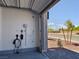 Modern garage with EV charger and door that opens to a tree-lined street at 6837 Crimson Lily St, Las Vegas, NV 89139