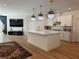 Open concept kitchen with island, stainless steel appliances, modern lighting, and backyard view at 6837 Crimson Lily St, Las Vegas, NV 89139