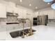 Close up of a kitchen sink and countertop, showcasing modern appliances and backsplash at 6837 Crimson Lily St, Las Vegas, NV 89139