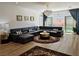Spacious living room featuring a modern sofa, area rug, and backyard access through sliding doors at 6837 Crimson Lily St, Las Vegas, NV 89139