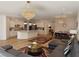 Open-concept living space featuring modern light fixtures, furnishings, and hardwood floors at 6837 Crimson Lily St, Las Vegas, NV 89139