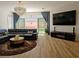 Inviting living room with modern furnishings, a mounted television, and backyard access at 6837 Crimson Lily St, Las Vegas, NV 89139