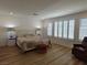 Bright main bedroom features wood floors, bedside tables, and plantation shutters at 6837 Crimson Lily St, Las Vegas, NV 89139