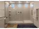Luxurious walk-in shower with a rainfall showerhead and bench seating at 6837 Crimson Lily St, Las Vegas, NV 89139
