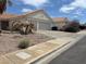 Charming home with a two-car garage and desert landscaping at 693 W Pacific Ave, Henderson, NV 89002