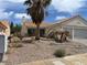 Charming single-story home with desert landscaping and a two-car garage at 693 W Pacific Ave, Henderson, NV 89002