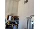 Interior wall with shelving and a mirror with peeling paint at 693 W Pacific Ave, Henderson, NV 89002
