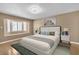 Relaxing bedroom with light colored walls, a large bed, stylish lamps, and a window seat below a bay window at 7604 Charles Conrad Cir, Las Vegas, NV 89145