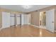 Bright bedroom featuring hardwood floors, closet space, and a connected bathroom with an updated shower at 7604 Charles Conrad Cir, Las Vegas, NV 89145