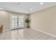Bright and airy room with tiled floors and doors leading to the outdoors at 7604 Charles Conrad Cir, Las Vegas, NV 89145