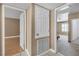 Hallway featuring doorways to a bedroom and living area, offering seamless transition throughout the home at 7604 Charles Conrad Cir, Las Vegas, NV 89145