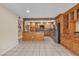 Spacious open-concept kitchen boasts custom cabinets and a tile floor at 7604 Charles Conrad Cir, Las Vegas, NV 89145