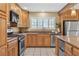 Kitchen features custom cabinets, stainless steel appliances, and granite countertops at 7604 Charles Conrad Cir, Las Vegas, NV 89145