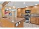 Well-lit kitchen features custom cabinets, granite countertops, and stainless steel appliances at 7604 Charles Conrad Cir, Las Vegas, NV 89145