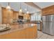 Bright kitchen with custom cabinets, stainless steel appliances, and granite countertops at 7604 Charles Conrad Cir, Las Vegas, NV 89145