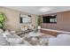 Cozy living room with plush seating, wood floors, and a stylish accent wall at 7604 Charles Conrad Cir, Las Vegas, NV 89145