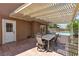 Covered patio with a dining table set overlooking the pool and well-kept outdoor area at 7604 Charles Conrad Cir, Las Vegas, NV 89145